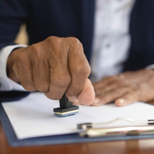 A notary public stamp being applied to a legal document